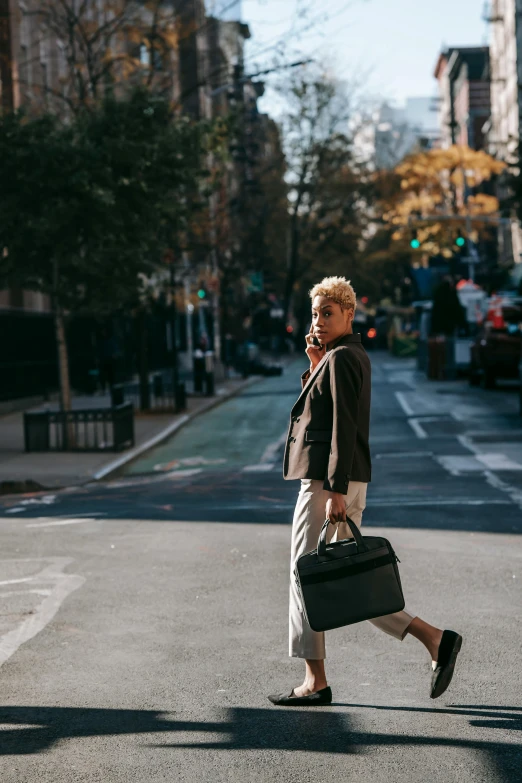 a woman crossing the street with a suitcase, trending on unsplash, short platinum hair tomboy, in a business suit, ignant, brooklyn