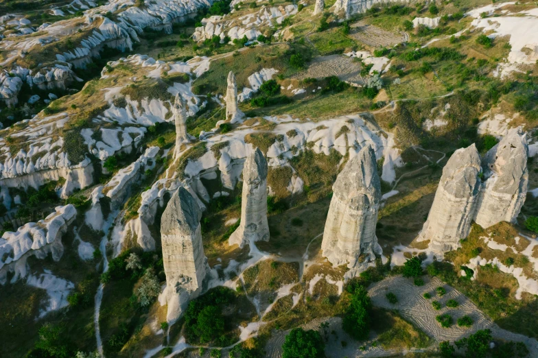 a bird's eye view of a rocky landscape, by Muggur, pexels contest winner, art nouveau, ivory towers, tall stone spires, summer evening, turkey