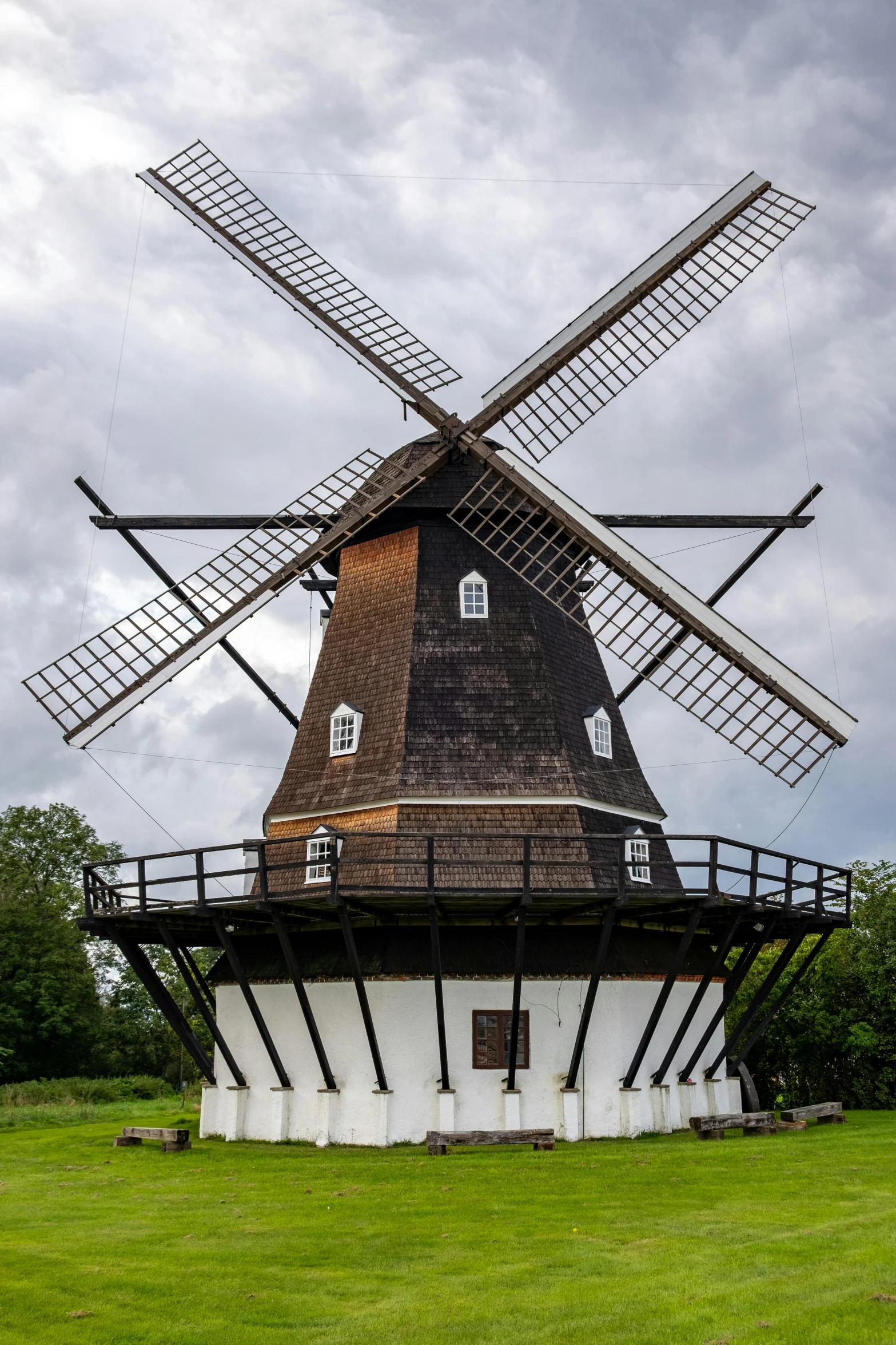 a windmill sitting on top of a lush green field, wooden structures, scandinavian / norse influenced, front side, sails