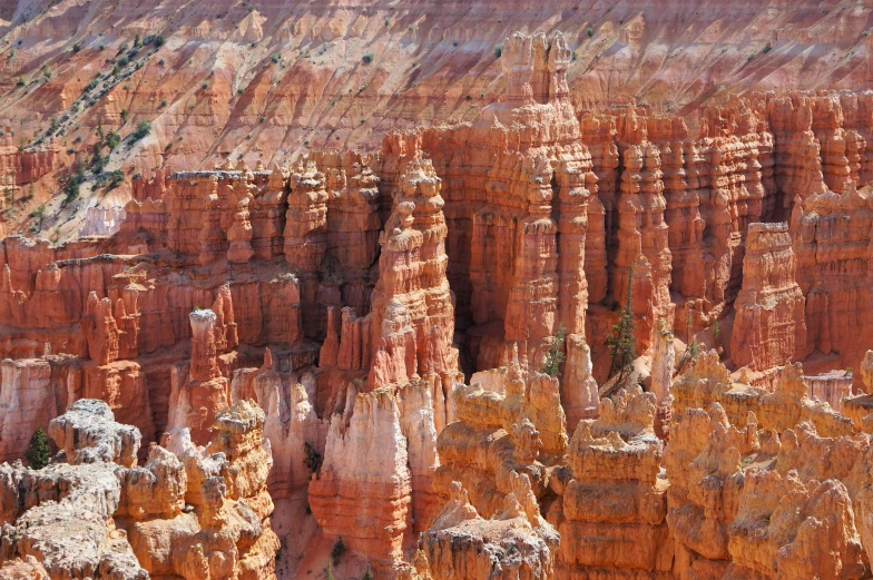 a large rock formation in the middle of a canyon, by David Simpson, pexels contest winner, tall stone spires, bryce 3 d style, zoomed in, panoramic