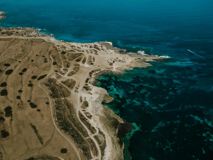 a large body of water next to a sandy beach, pexels contest winner, les nabis, aerial view of an ancient land, bulli, views to the ocean, cinematic lut