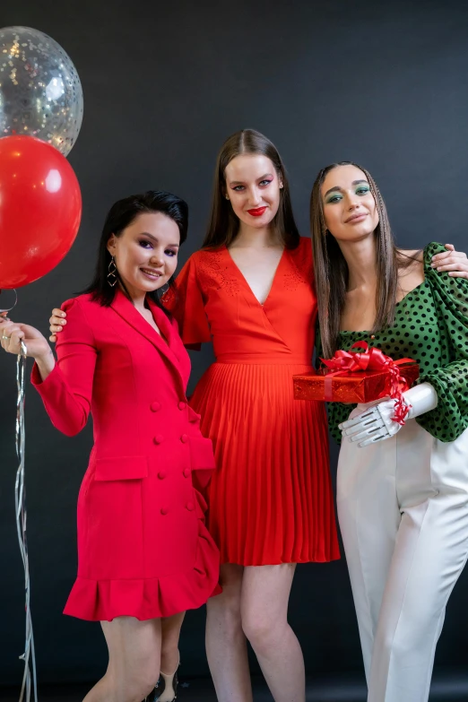 a group of three women standing next to each other, pexels contest winner, wearing a red outfit, baloons, bella poarch, wearing a cocktail dress