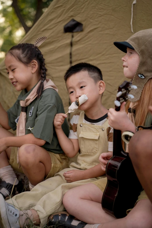 a group of children sitting next to each other, glamping, scout boy, damien tran, performance