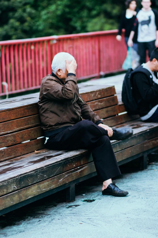 a man sitting on top of a wooden bench, trending on unsplash, two old people, facepalm, white-haired, asian male