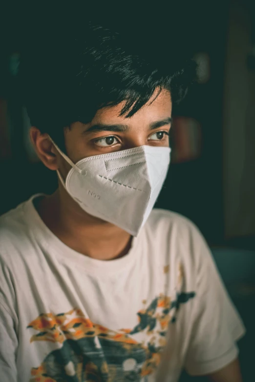 a close up of a person wearing a face mask, a picture, vinayak, teenage boy, serious expression, healthcare