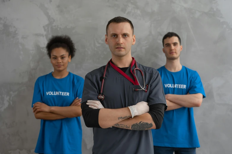 a group of men standing next to each other, pexels contest winner, nurse scrubs, gray, background image, vitalik buterin