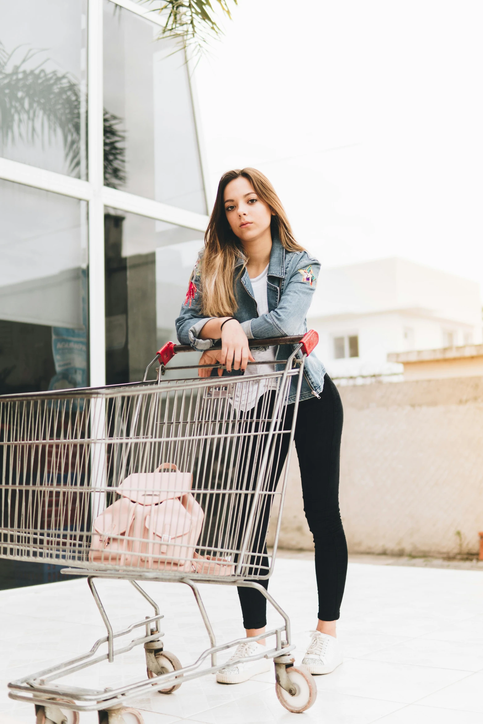 a woman standing next to a shopping cart, pexels contest winner, realism, madison beer, trending on vsco, jean jacket, getting groceries