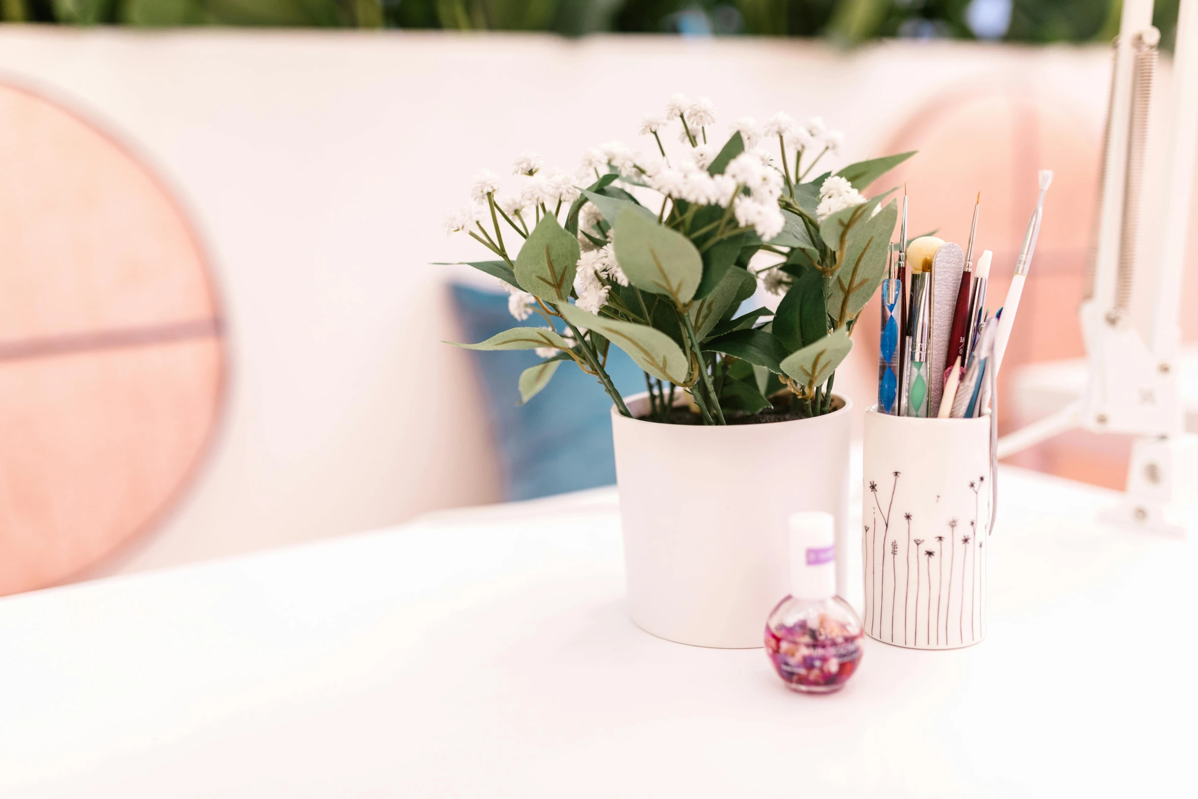 a potted plant sitting on top of a white table, inspired by Eden Box, process art, holding paintbrushes, painted nails, lacey accessories, detailed product shot