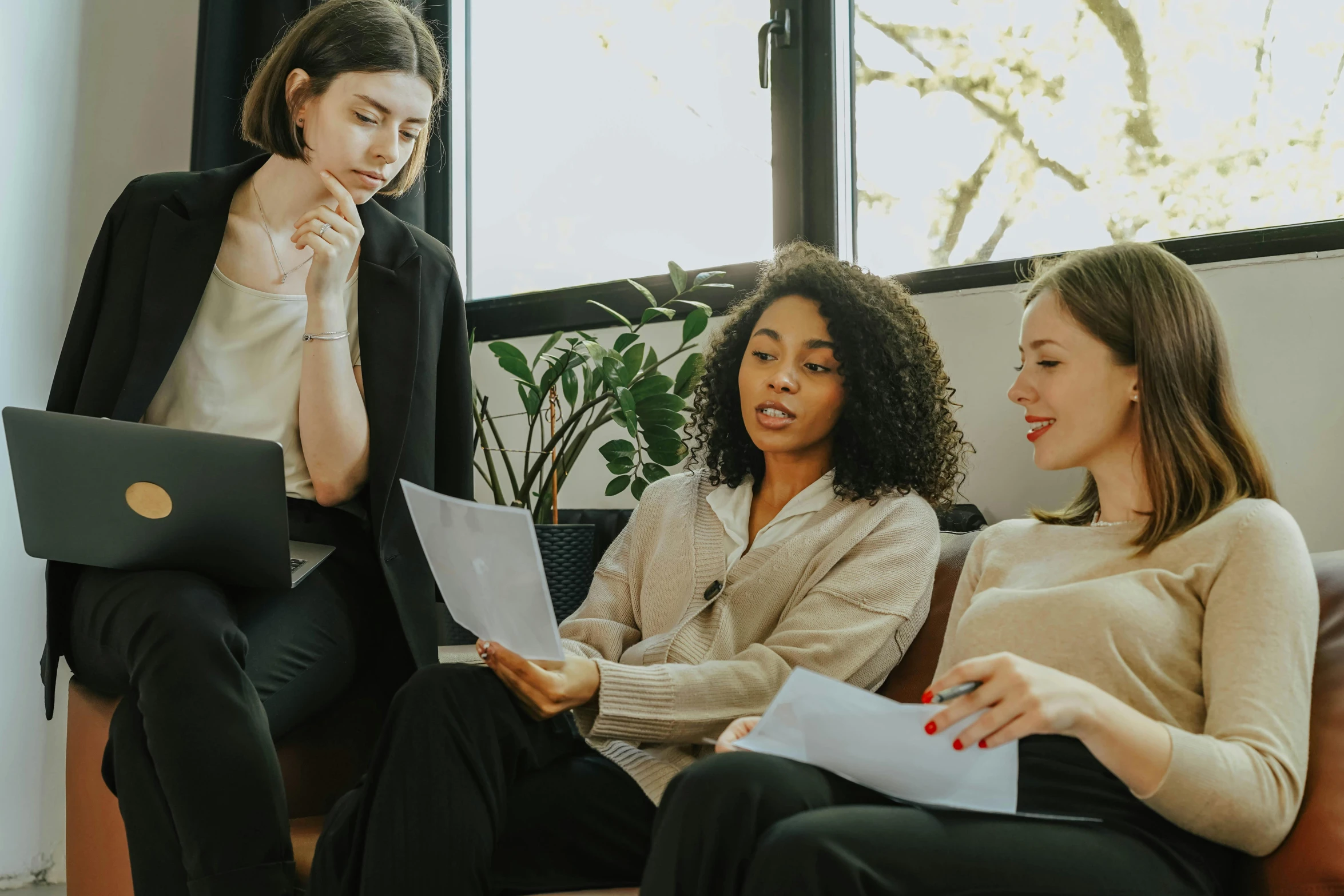 three women sitting on a couch with laptops, trending on pexels, avatar image, background image, professional image, woman holding another woman