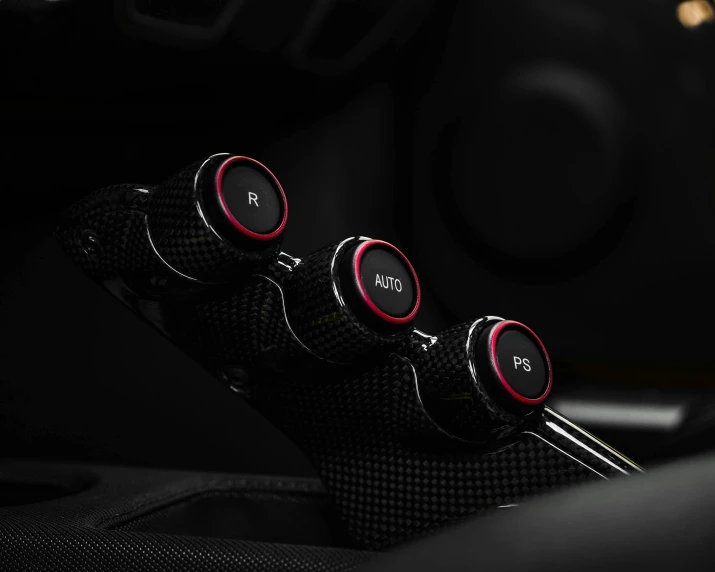 a close up of a steering knob in a car, black and red colour palette, professional product photography, three, controllers