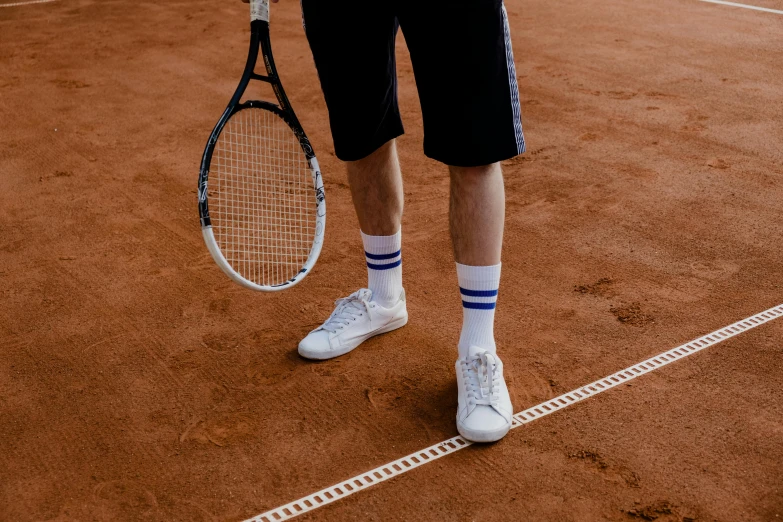 a man standing on a tennis court holding a racquet, inspired by Hans Mertens, pexels contest winner, striped socks, white clay, 15081959 21121991 01012000 4k, medium height