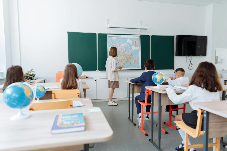 a group of children sitting at desks in a classroom, a cartoon, by Adam Marczyński, pexels contest winner, danube school, full body wide shot, decoration, background image, standing on a desk