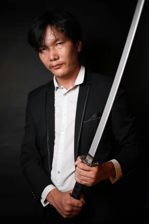 a man in a suit holding a sword, inspired by Jason Teraoka, profile image, professional profile photo, profile pic, nivanh chanthara