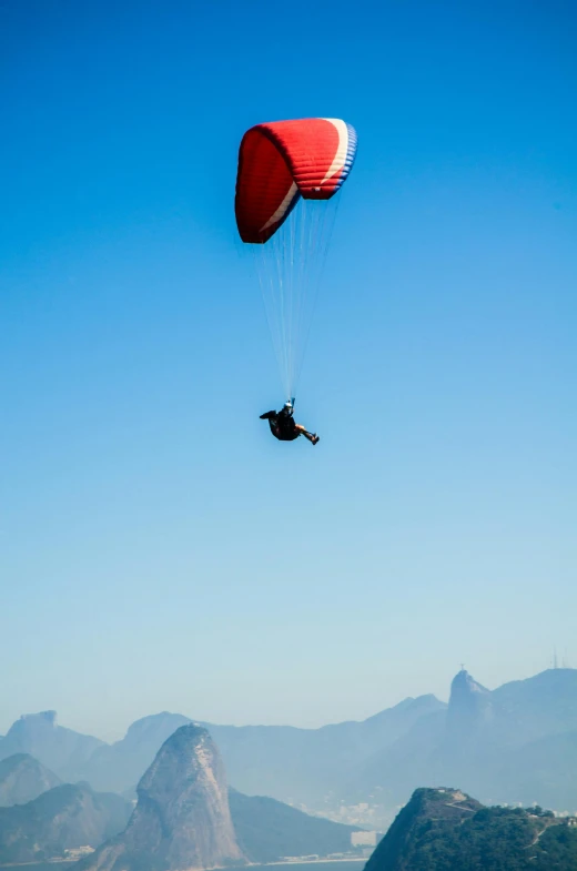 a person that is in the air with a parachute, rio de janeiro, aerodynamic!!!!!!, telephoto shot, - n 9