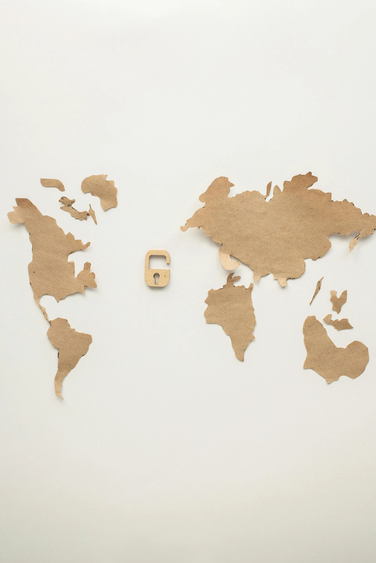 a map of the world cut out of cardboard, by Will Ellis, trending on pexels, conceptual art, pareidolia, map key, global light, plain background