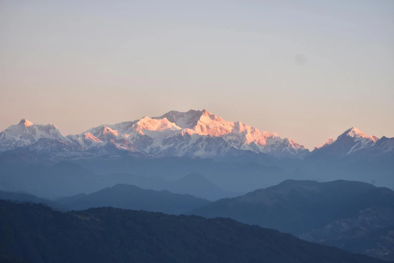 a mountain range with snow capped mountains in the distance, pexels contest winner, sumatraism, assamese, profile image, warm light, pink