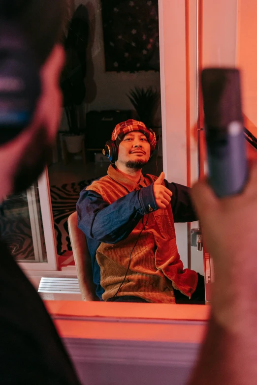 a man taking a picture of himself in a mirror, an album cover, trending on pexels, wearing gaming headset, rapping into microphone, indoor scene, mark edward fischbach