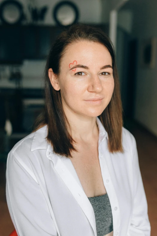 a woman in a white shirt sitting on a red chair, trending on reddit, hyperrealism, lightning bolt scar on forehead, portrait of a female pathologist, stood in a lab, dasha taran