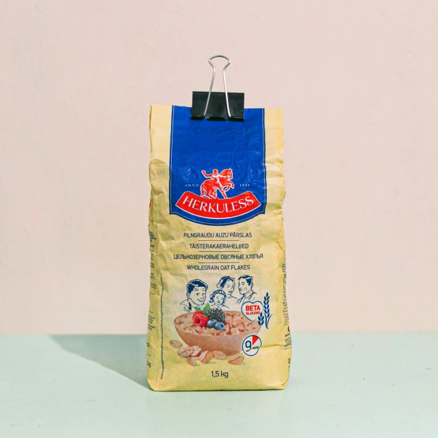 a bag of food sitting on top of a table, inspired by Josefina Tanganelli Plana, dribble, in a style blend of botticelli, on a pale background, bakery, official product image