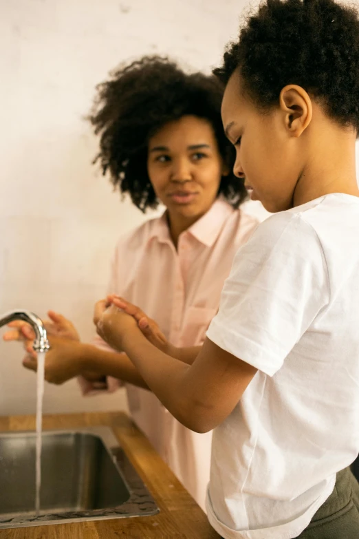 a woman and a child washing their hands in a sink, pexels, teenage girl, varying ethnicities, square, screensaver