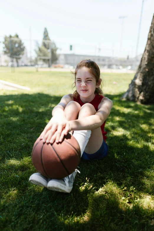 a girl sitting in the grass with a basketball, by Greg Spalenka, dribble contest winner, documentary still, sophia lillis, getty images proshot, 15081959 21121991 01012000 4k