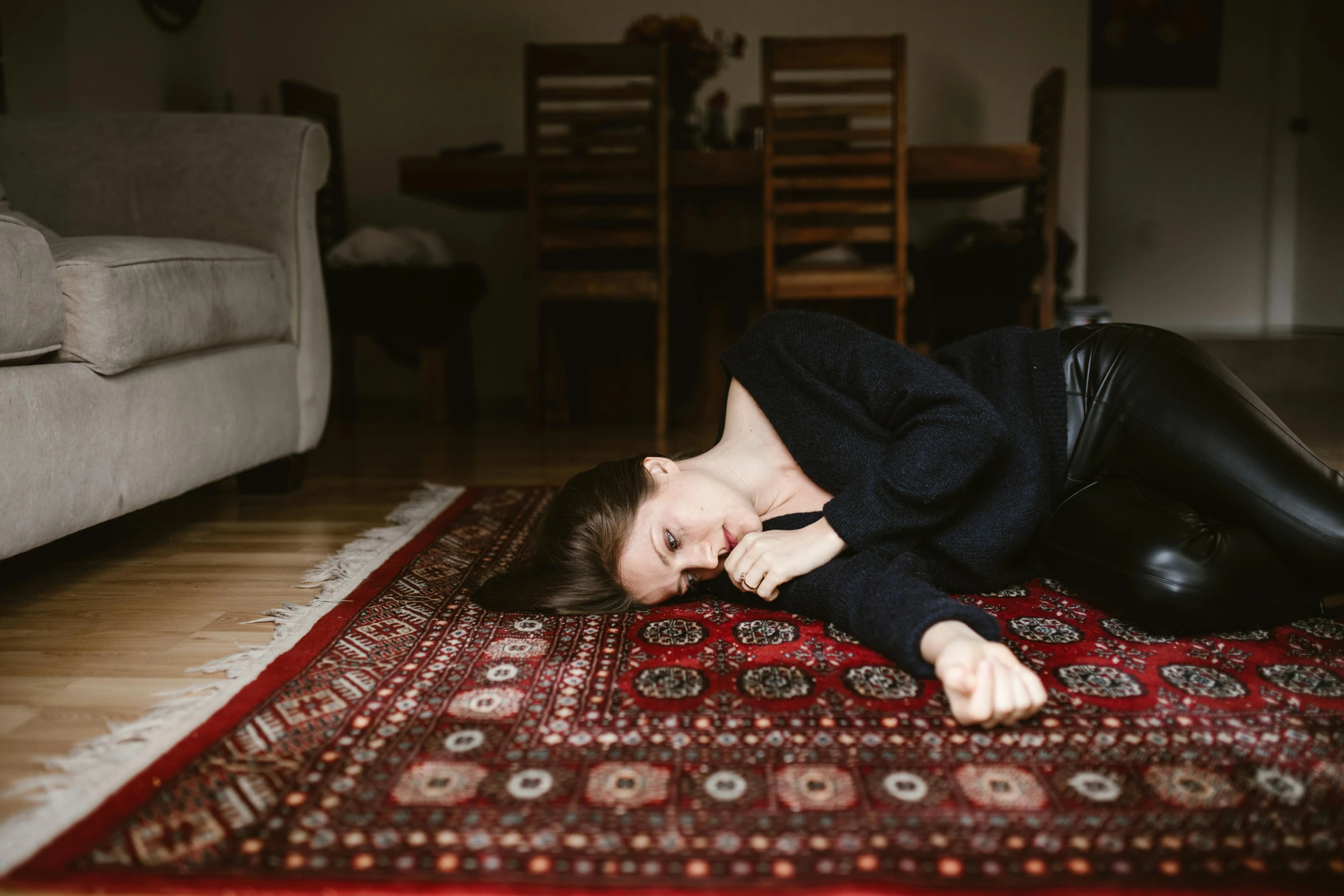 a woman laying on a rug on the floor, by Julia Pishtar, pexels contest winner, hurufiyya, in pain, 15081959 21121991 01012000 4k, furniture overturned, profile image