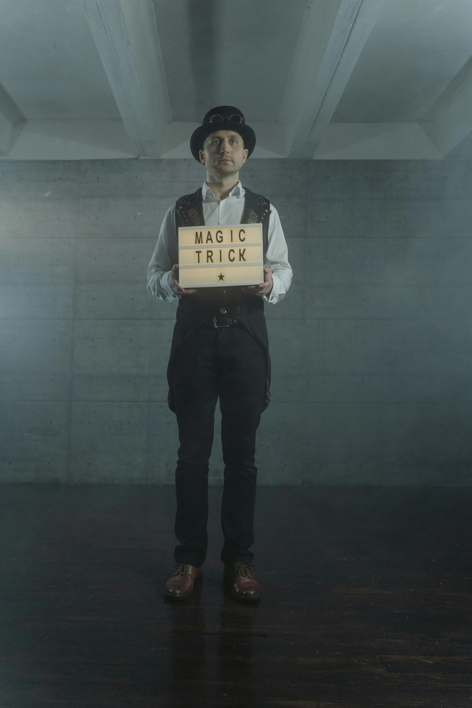 a man standing in a room holding a sign, inspired by Max Klinger, magical realism, houdini sidefx, video still, trick, brick