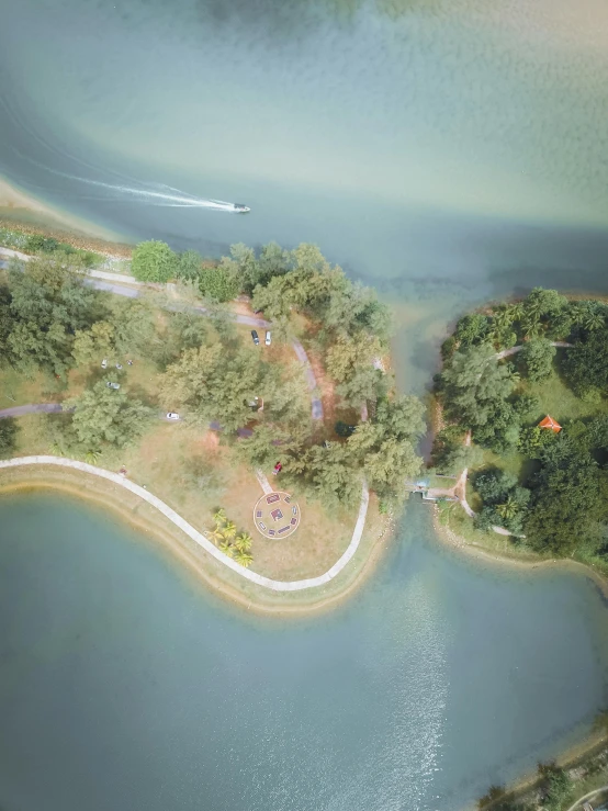 an aerial view of a body of water, singapore ( 2 0 1 8 ), in a park and next to a lake, drone photograpghy, photorealistic photo