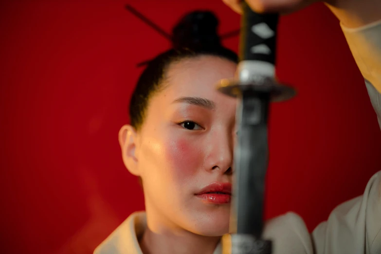 a close up of a person holding a knife, a portrait, inspired by Yasuo Kuniyoshi, pexels contest winner, shin hanga, portrait of mulan, colored photo, hito steyerl, holding two swords