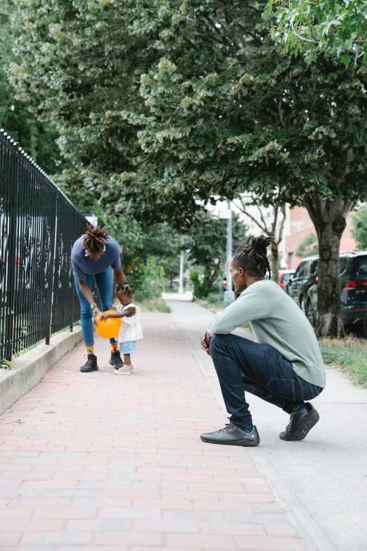 a little girl riding a skateboard down a sidewalk, by Washington Allston, unsplash, visual art, man sitting facing away, of a family standing in a park, schomburg, calmly conversing 8k