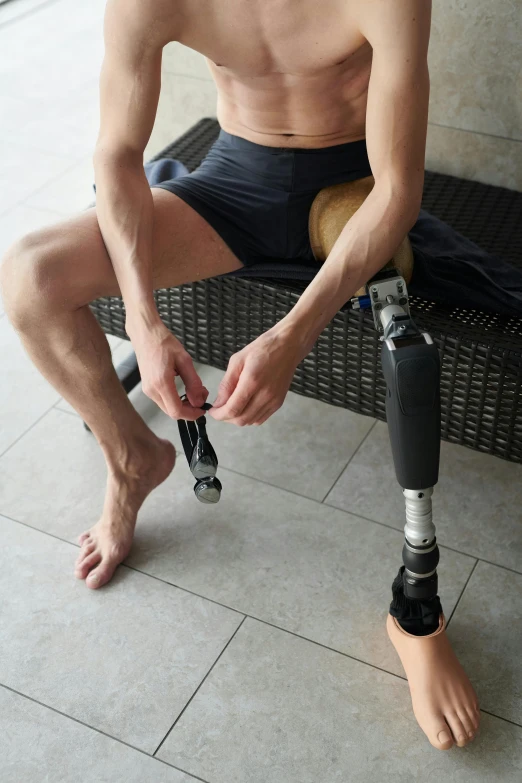 a man with a prosthetic device sitting on a bench, bare leg, promo image, at home, splash image