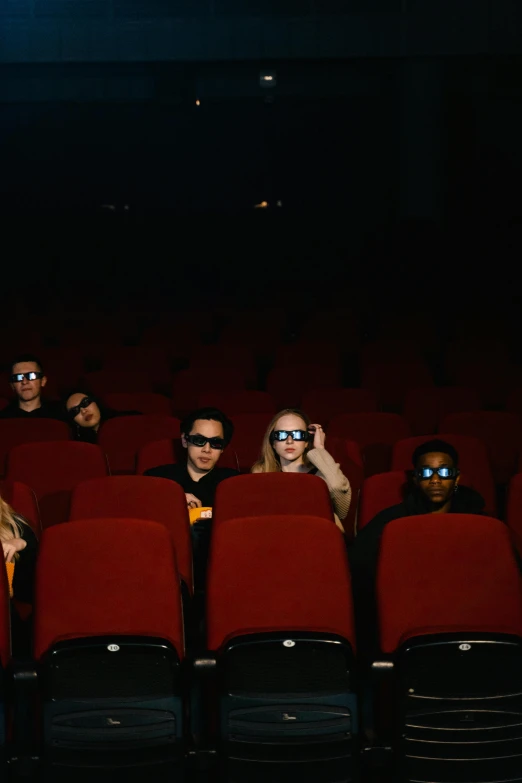 a group of people sitting in a movie theater