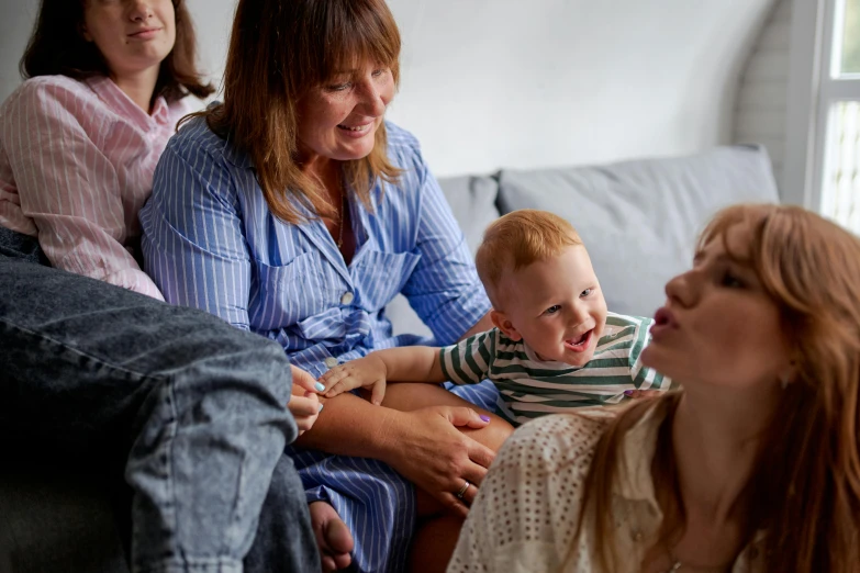 three women and a baby sitting on a couch, pexels, avatar image, families playing, close up photograph, ad image