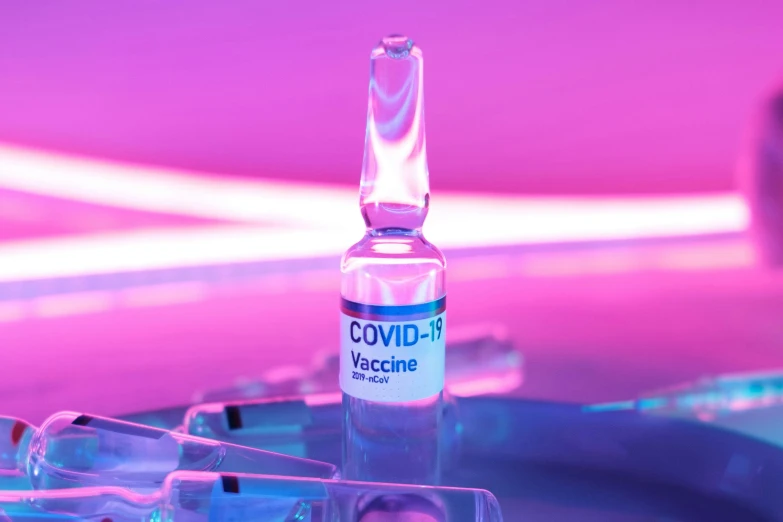 a bottle of vaccine sitting on top of a table, a digital rendering, by Jeanna bauck, shutterstock, purple and pink and blue neons, deblur, ƒ/5.6, colour corrected