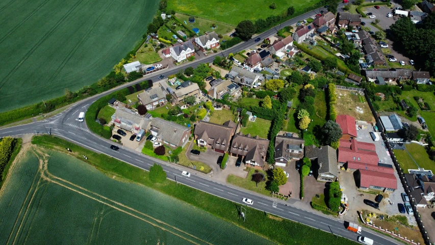 a bird's eye view of a small town, by Julian Allen, commercial photograph, mayfield parish, hedges, airborne view