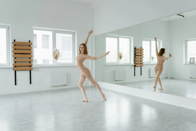 a woman that is standing in front of a mirror, by Elizabeth Polunin, pexels contest winner, arabesque, full body 8k, bare room, she is dancing, high-quality photo