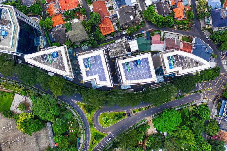 an aerial view of a city with lots of buildings, by Carey Morris, shutterstock, rooftop solar panels, bali, high angle uhd 8 k, square