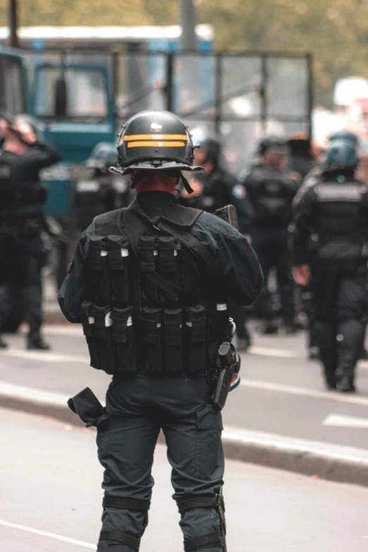 a group of police officers walking down a street, reddit, renaissance, tactical vest, foreground background, 🚿🗝📝, france