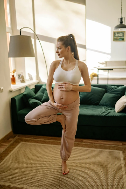 a pregnant woman doing yoga in a living room, shutterstock, arabesque, thumbnail, high quality picture, standing, cotton
