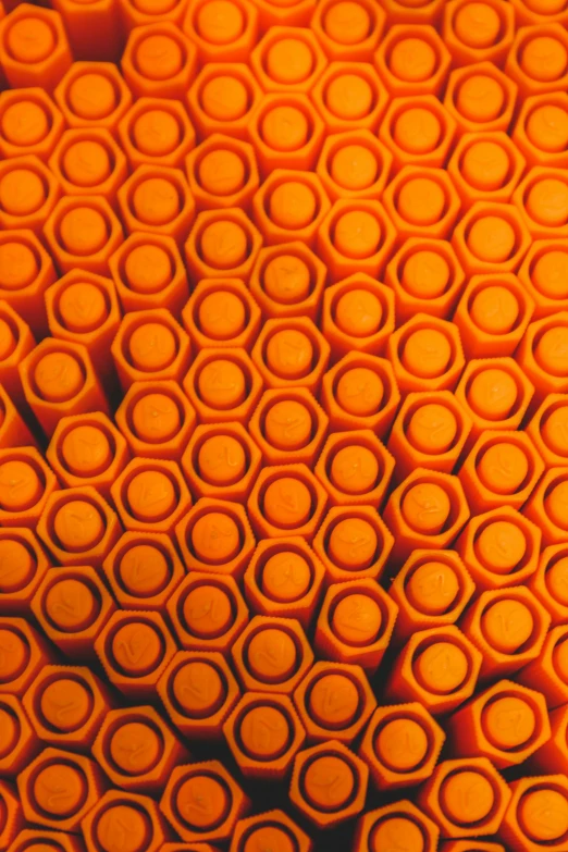 a bunch of orange tubes stacked on top of each other, a microscopic photo, trending on zbrush central, op art, precise stippling, hexagonal, indie film, shot from above