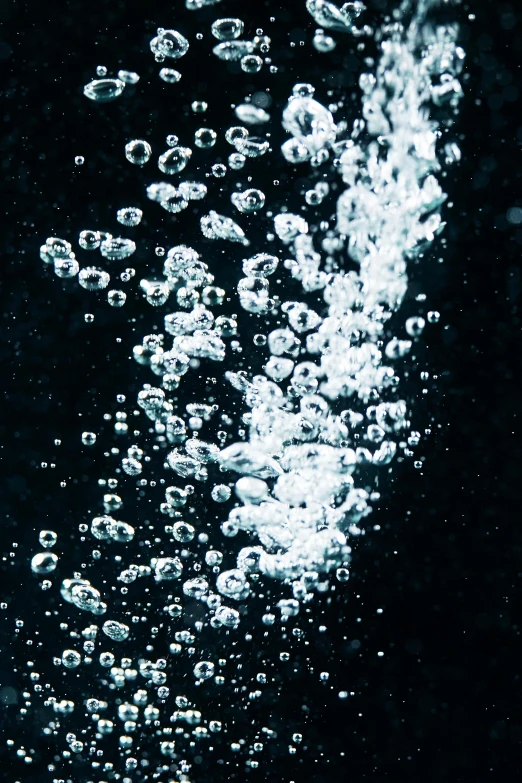 a close up of a cell phone with bubbles coming out of it, an album cover, inspired by Elsa Bleda, unsplash, digital art, black water, hydration, high - contrast, swimming