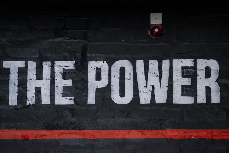 a brick wall with the word the power painted on it, trending on pexels, pub sign, background image, barbara kruger, electricity superpowers