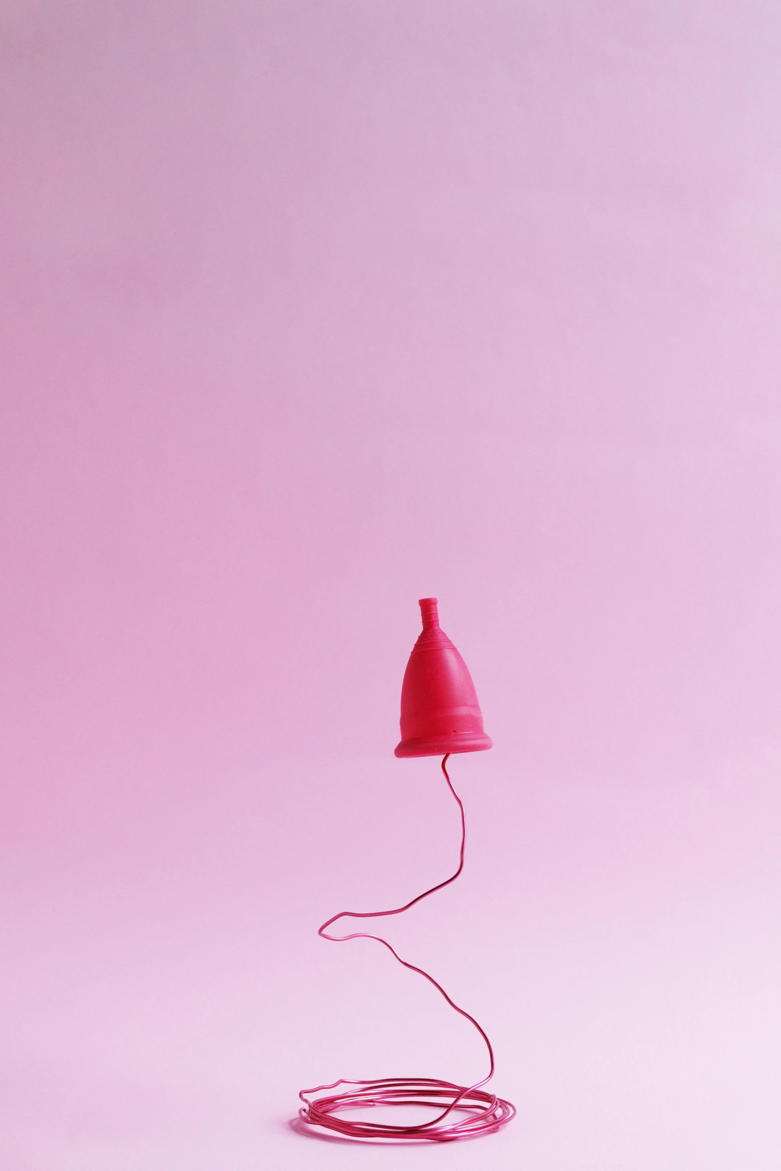 a red lamp sitting on top of a pink floor, trending on pexels, surgical iv drip, contracept, dunce, balloon