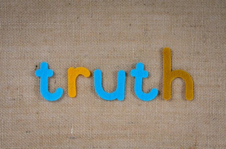 the word truth spelled in blue and yellow letters, by Ruth Simpson, unsplash, burlap, teal and orange colours, rebirth rituals, schools