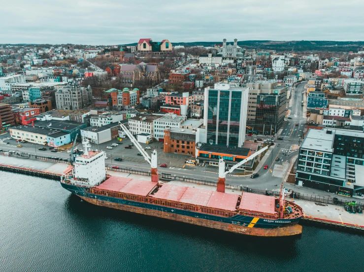 a large ship in the middle of a large body of water, by Brian Snøddy, pexels contest winner, graffiti, drone view of a city, port, nina tryggvadottir, thumbnail