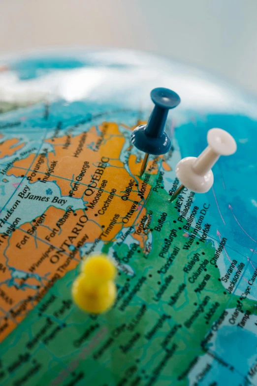 a close up of a globe with pins on it, slide show, road trip, multiple stories, list