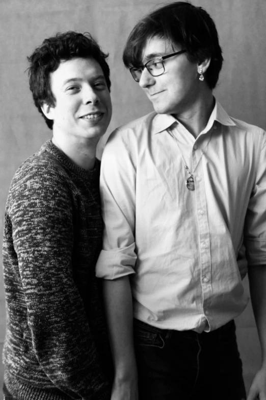 a couple of men standing next to each other, a black and white photo, by Adam Chmielowski, ben folds portrait, julian ope, two male, lesbians