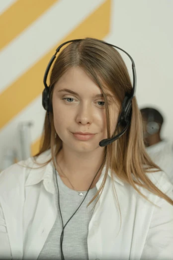 a woman wearing a headset sitting in front of a computer, a colorized photo, trending on pexels, portrait of white teenage girl, calmly conversing 8k, worksafe. cinematic, h3h3