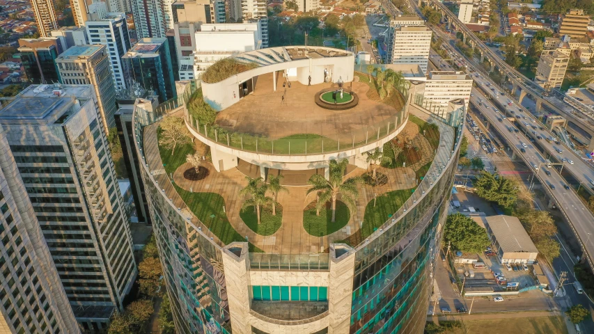 a view of a city from the top of a building, by Luis Miranda, rounded architecture, parks and public space, sri lanka, perched on a skyscraper