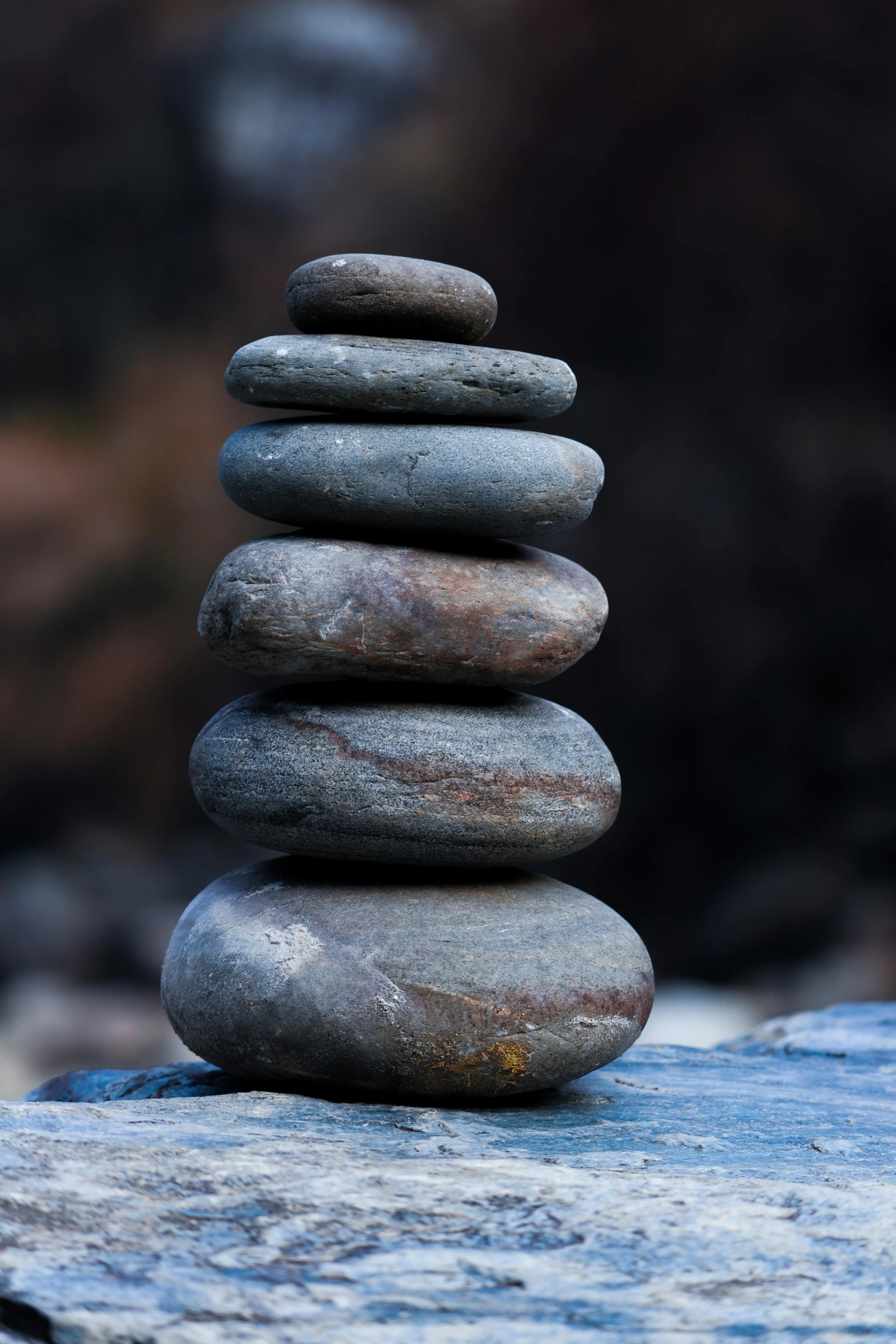 a stack of rocks sitting on top of a rock, inspired by Andy Goldsworthy, unsplash, paul barson, spa, modeled, signed